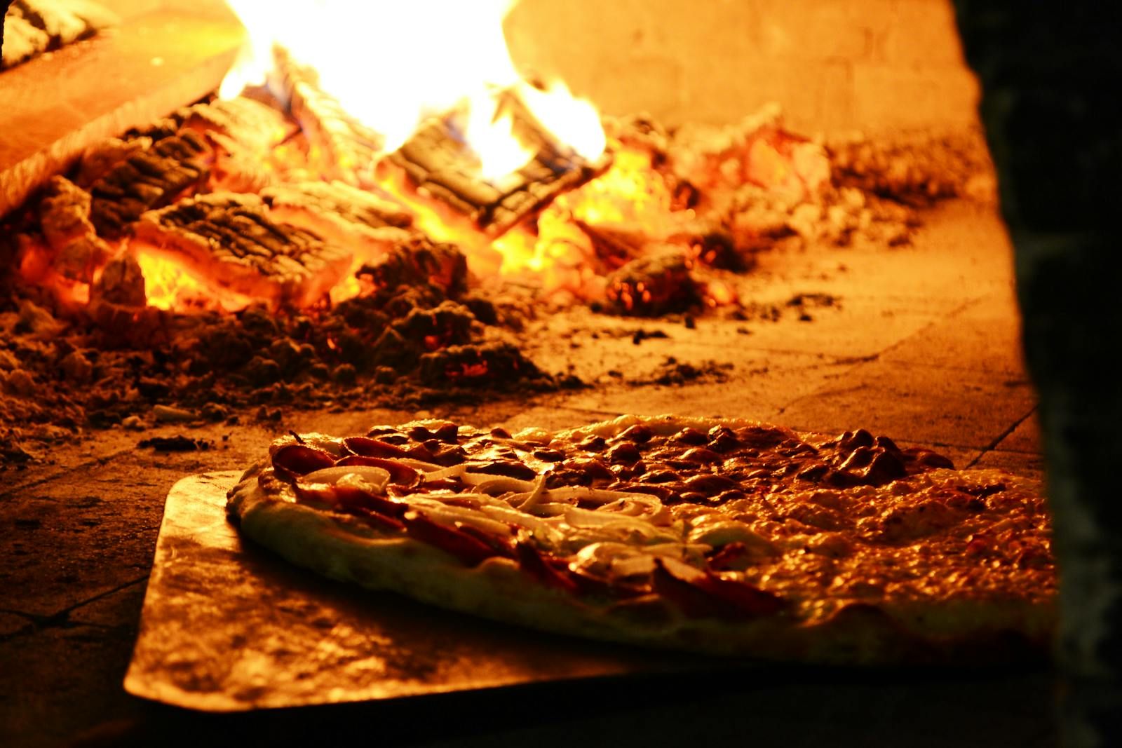Pizza cooking in a wood-fired oven