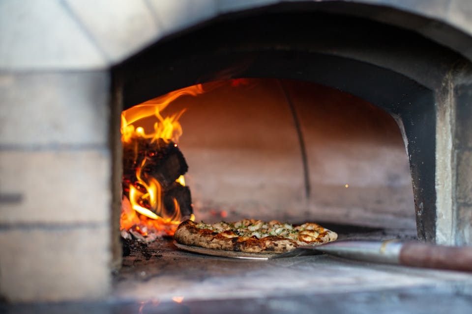 Artisan pizza baking in an oven