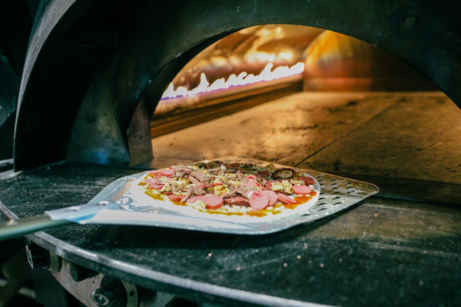 Fresh pizza in a wood-fired stone oven